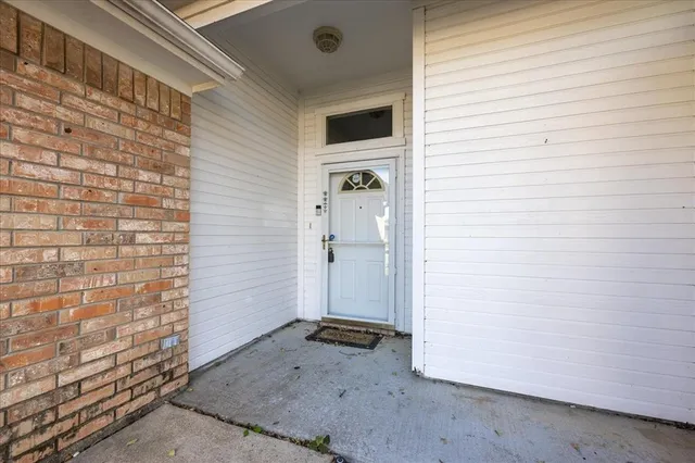 a view of a livingroom with wooden floor and a bathroom