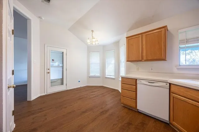 a kitchen with stainless steel appliances granite countertop a sink a stove a refrigerator with grey cabinets