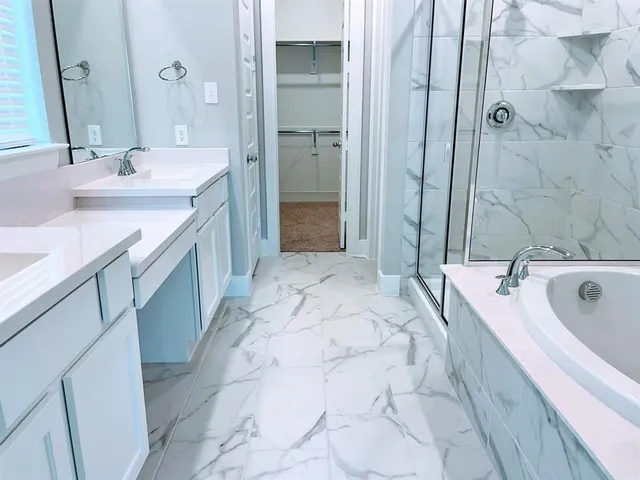 a bathroom with a tub sink and mirror