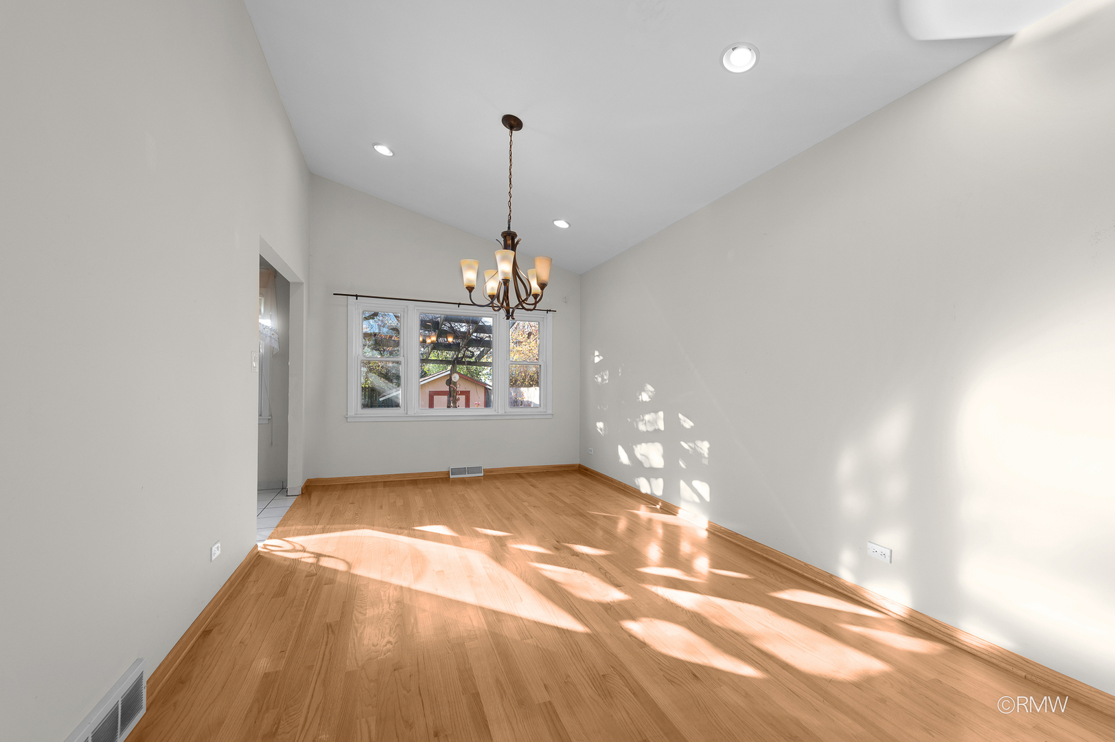 18 South Vista Avenue Addison, IL 60101 - Photo 6 of 32 a view of a chandelier in big room with windows