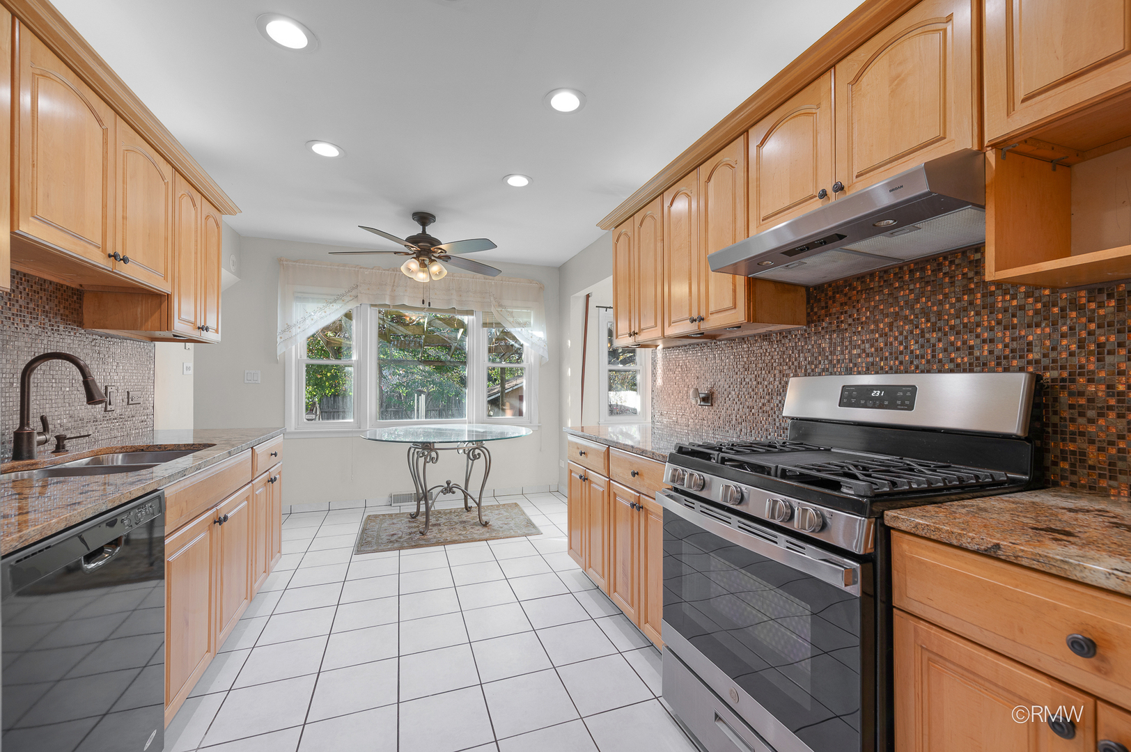 18 South Vista Avenue Addison, IL 60101 - Photo 8 of 32 a kitchen with stainless steel appliances granite countertop a stove a sink and a microwave