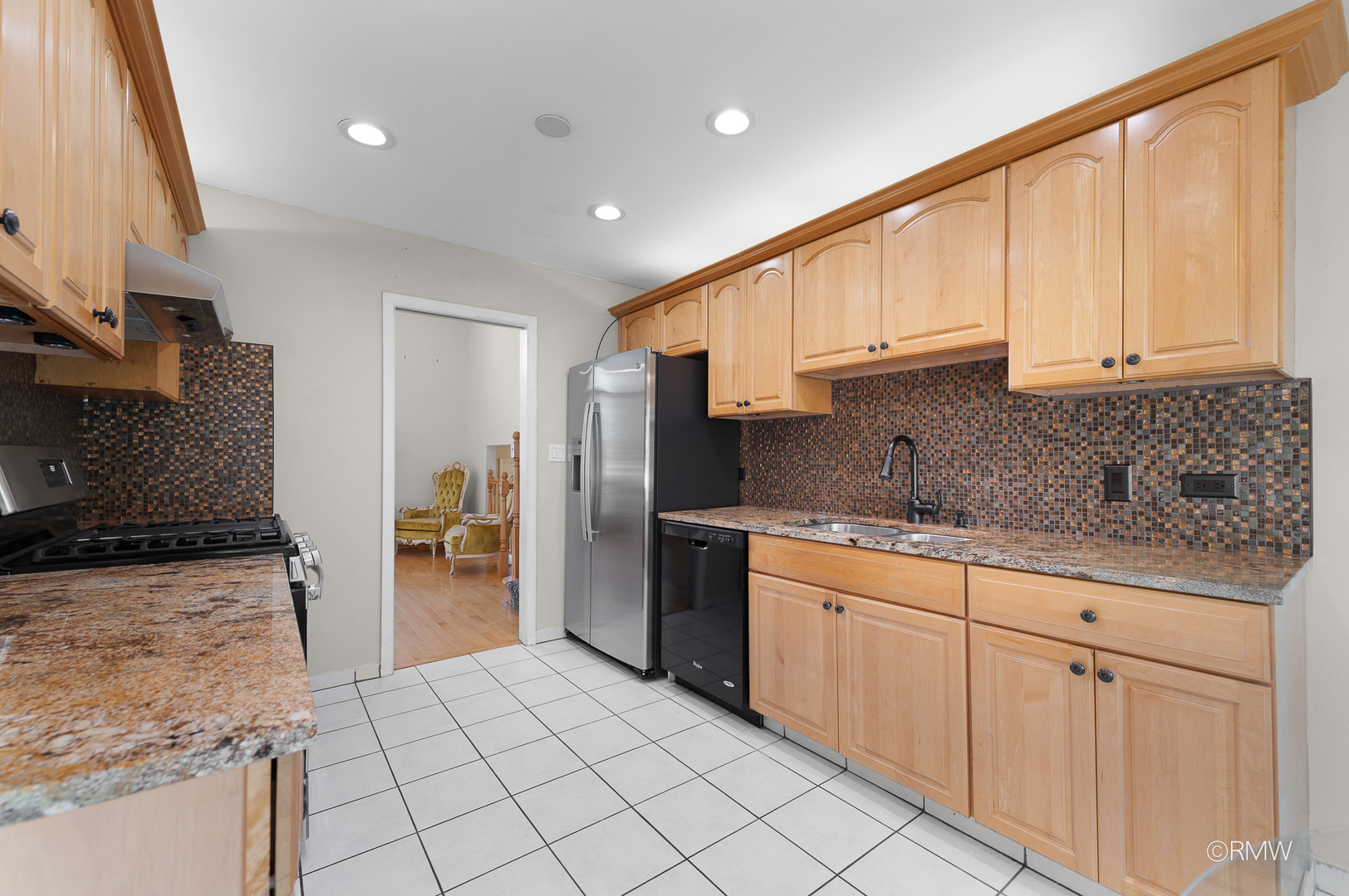 18 South Vista Avenue Addison, IL 60101 - Photo 10 of 32 a kitchen with stainless steel appliances granite countertop a stove a sink and a refrigerator