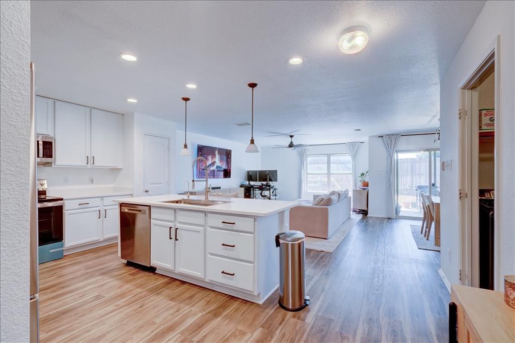 6233 Skysail Road Fort Worth, TX 76179 - Photo 11 of 30 a kitchen with a sink stove cabinets and wooden floor