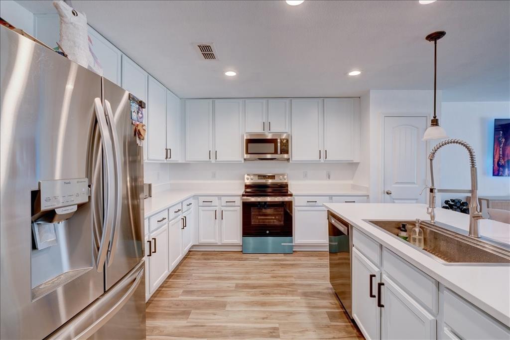 6233 Skysail Road Fort Worth, TX 76179 - Photo 12 of 30 a kitchen with granite countertop a refrigerator stove and sink