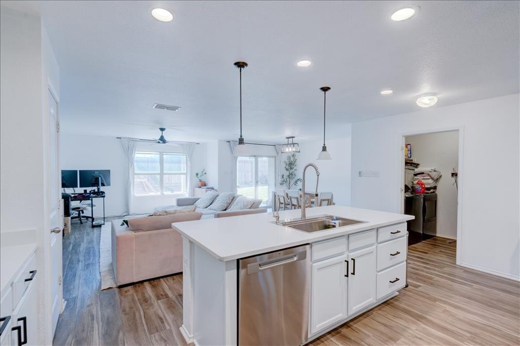 6233 Skysail Road Fort Worth, TX 76179 - Photo 13 of 30 a kitchen with sink refrigerator and microwave