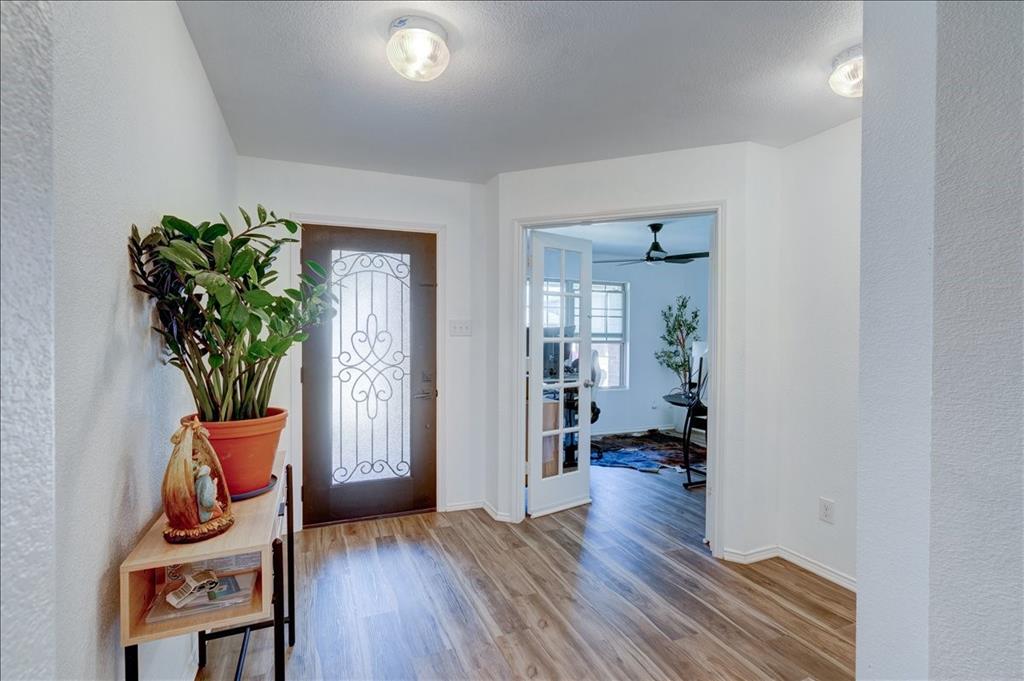 6233 Skysail Road Fort Worth, TX 76179 - Photo 24 of 30 a hallway with wooden floor and a potted plant