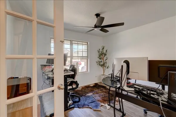 a bedroom with a bed a window and a chandelier