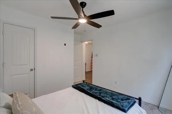 a view of a hallway with wooden floor and closet