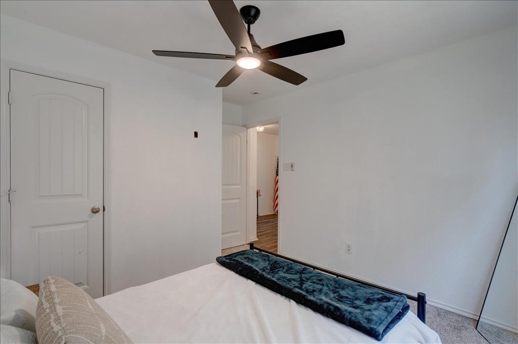 6233 Skysail Road Fort Worth, TX 76179 - Photo 8 of 30 a bedroom with a bed and a chandelier fan
