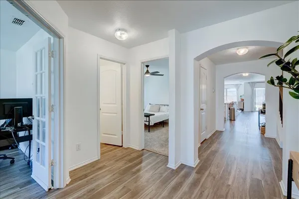 a view of entryway and hall with wooden floor