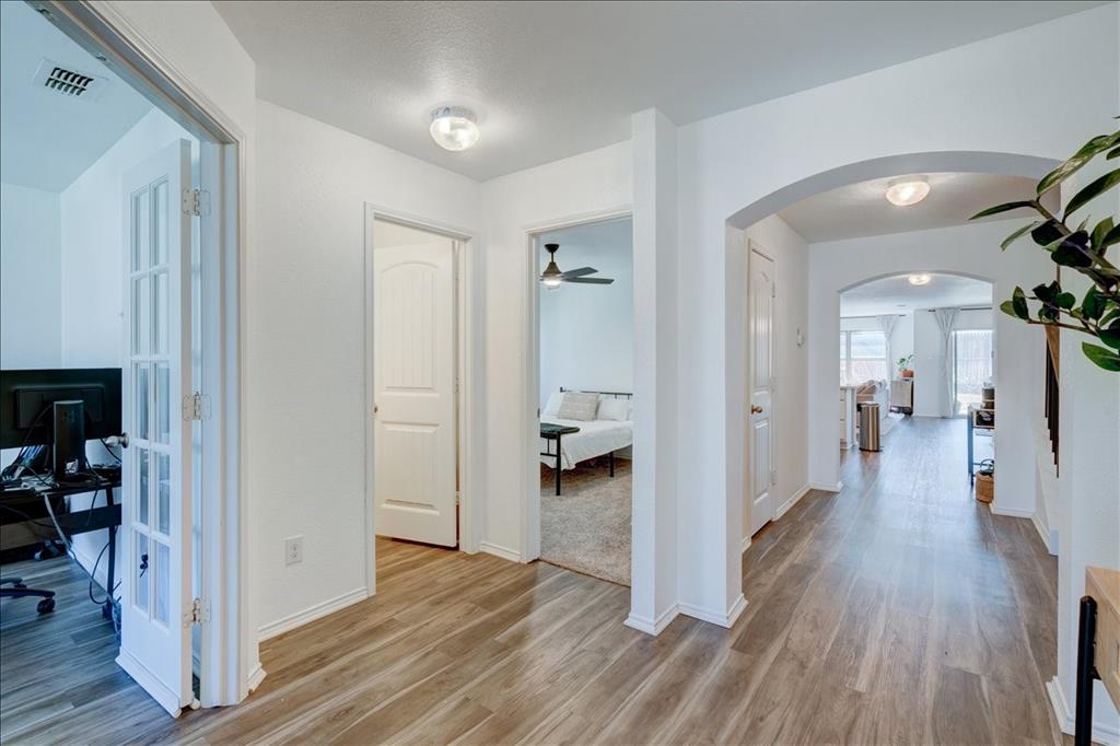 6233 Skysail Road Fort Worth, TX 76179 - Photo 9 of 30 a view of a hallway with wooden floor and closet