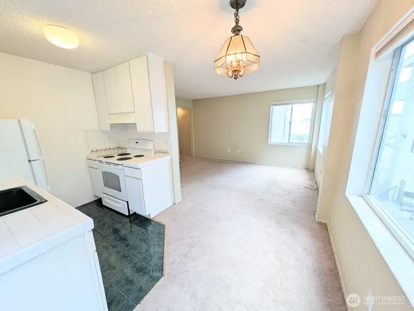 a bathroom with a granite countertop sink toilet a mirror and shower