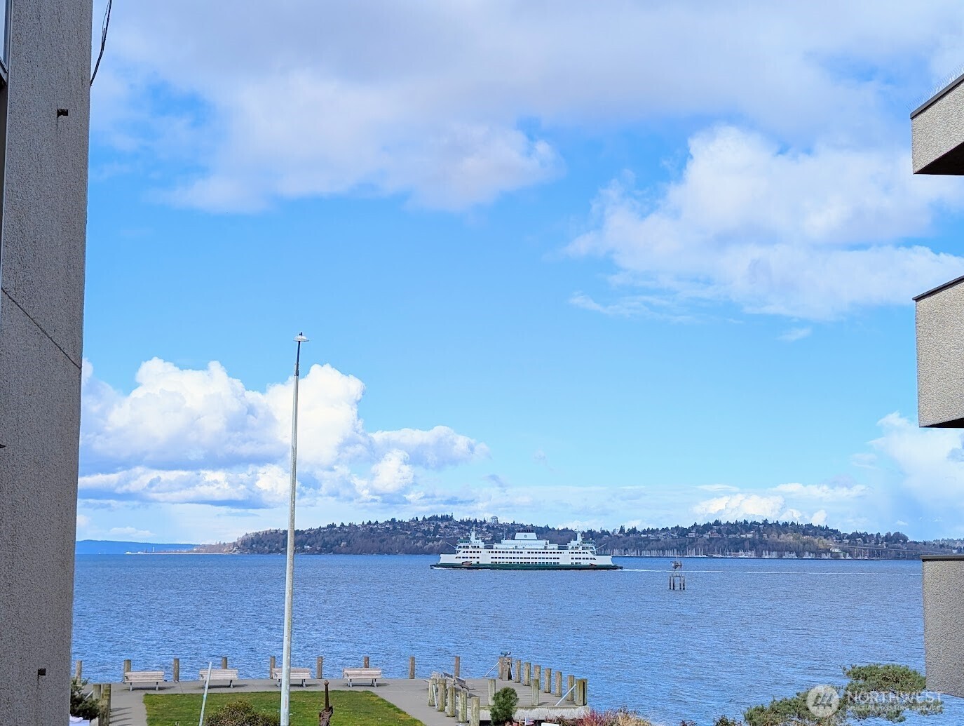 1156 Alki Avenue Southwest, Unit 201 Seattle, WA 98116 - Photo 2 of 40 a view of a lake with a city skyline in the background