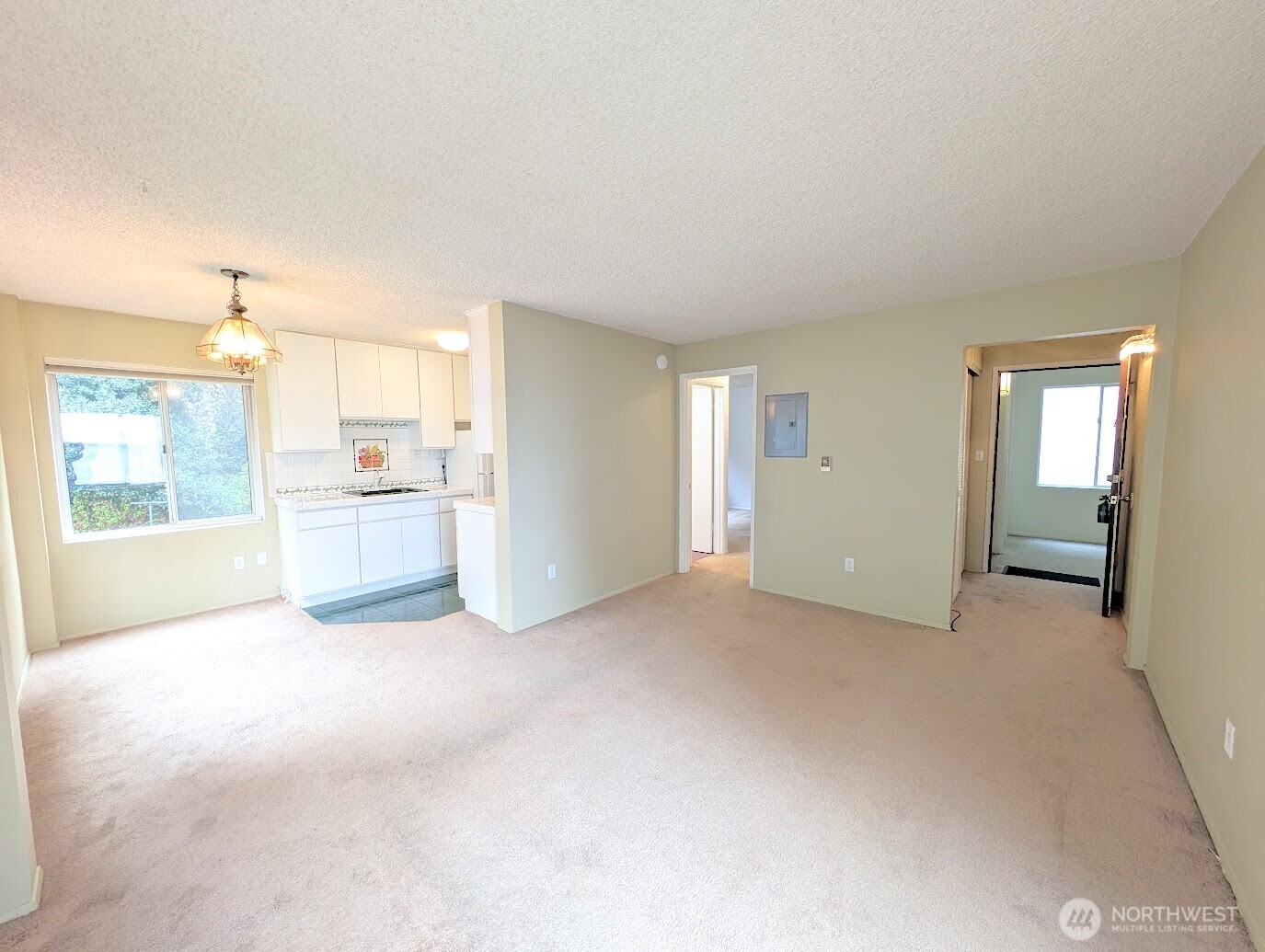 1156 Alki Avenue Southwest, Unit 201 Seattle, WA 98116 - Photo 4 of 40 a view of a kitchen with a sink and a window