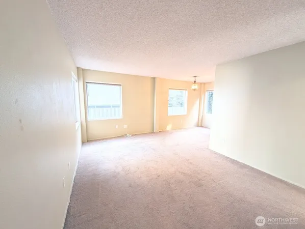 an empty room with windows and closet