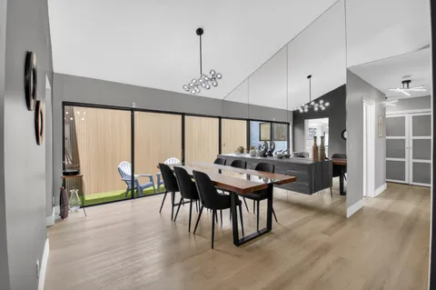 a spacious bedroom with a bed a table and chair