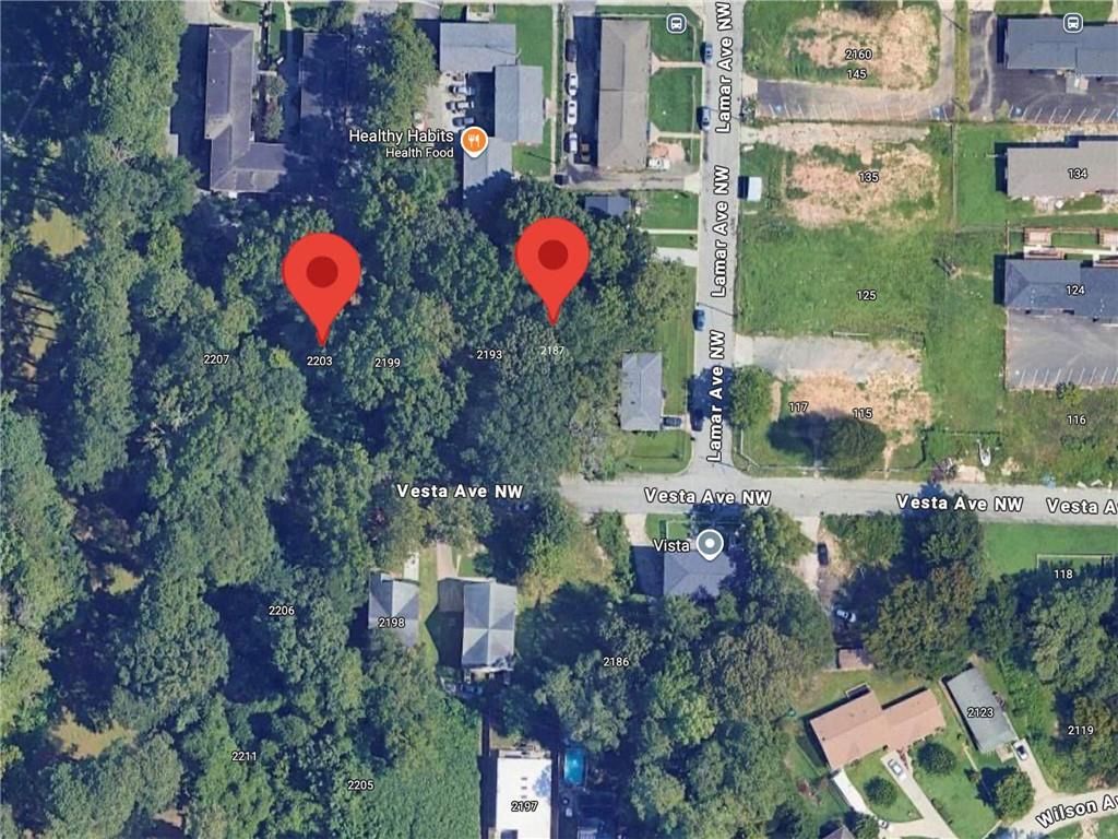 an aerial view of house with yard and swimming pool