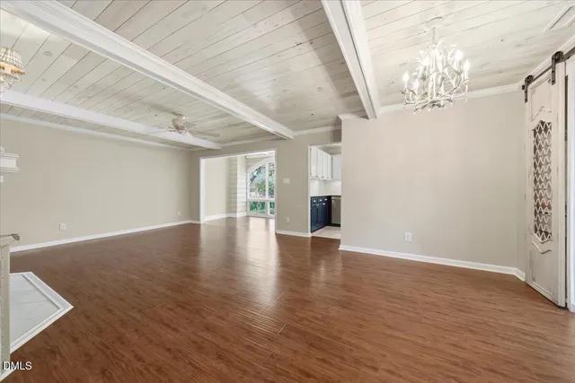 a kitchen with stainless steel appliances granite countertop a sink and cabinets with wooden floor