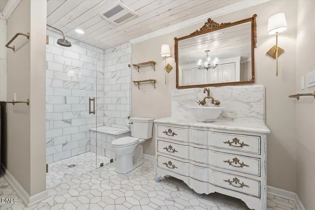 a view of backyard with a table and chairs and potted plants