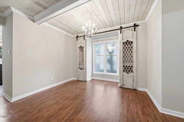 a view of a livingroom with wooden floor and a fireplace