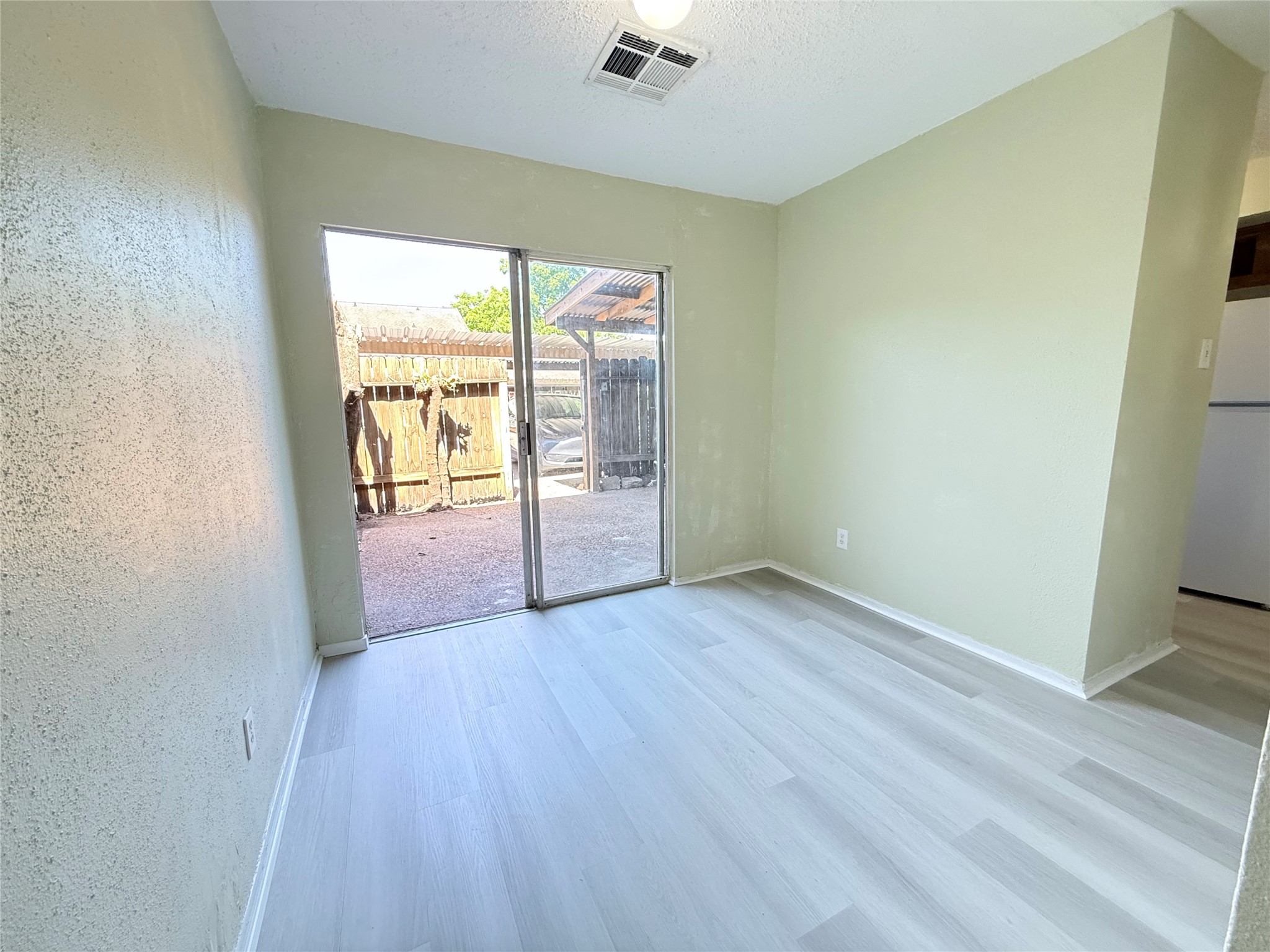 7789 Cook Road Houston, TX 77072 - Photo 6 of 18 an empty room with wooden floor and windows