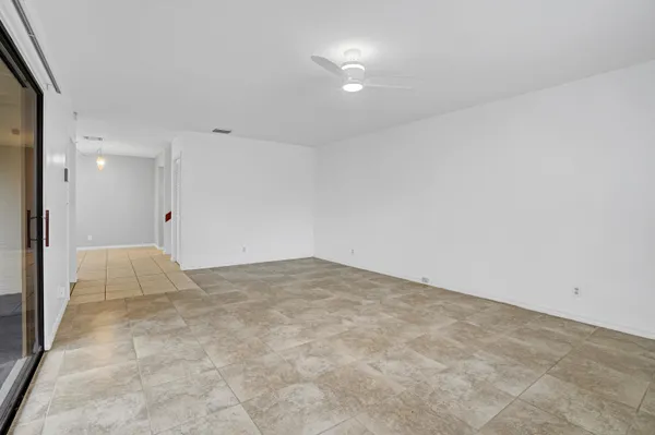 an empty room with an entrance to other room