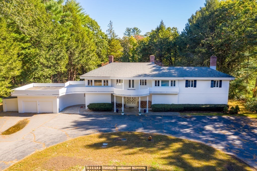 7 Turtle Lane Dover, MA 02030 - Photo 2 of 34 a front view of a house with a garden and deck