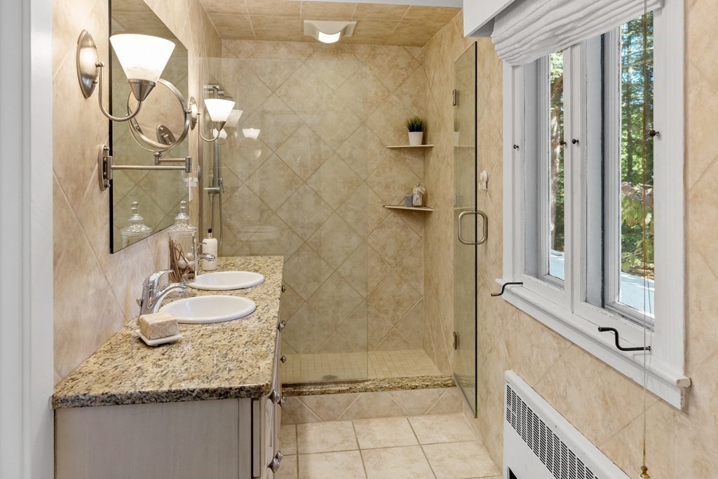 7 Turtle Lane Dover, MA 02030 - Photo 24 of 34 a bathroom with a granite countertop shower a mirror and a sink