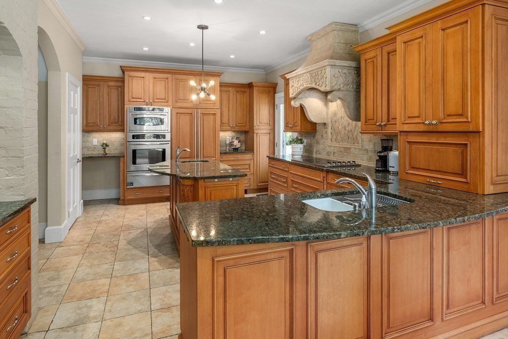 7 Turtle Lane Dover, MA 02030 - Photo 10 of 34 a kitchen with stainless steel appliances granite countertop a sink and a refrigerator