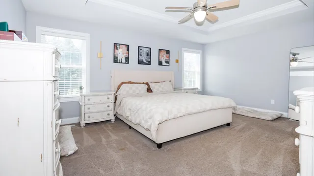 a spacious bathroom with a double vanity sink a mirror and a toilet