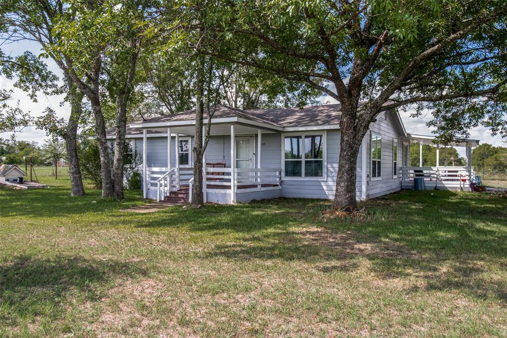 9309 West Ridge Road Anna, TX 75409 - Photo 1 of 28 Photos taken in the spring to showcase the pecan trees in the front and side of the home.