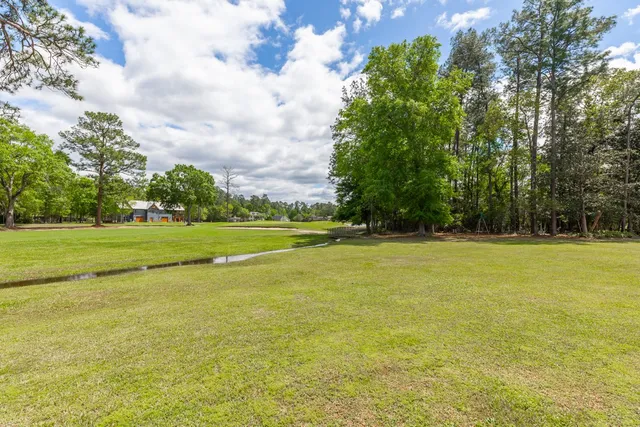 a view of a swimming pool and a yard