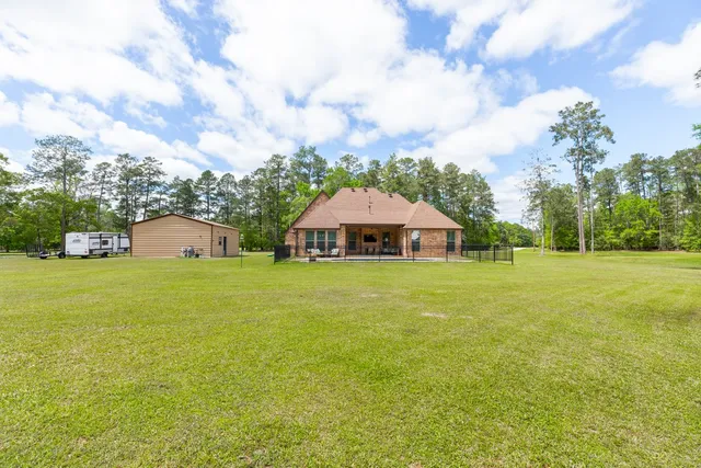 a aerial view of a house with swimming pool and a big yard