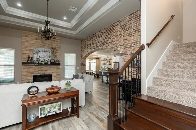 a living room with fireplace furniture and a chandelier