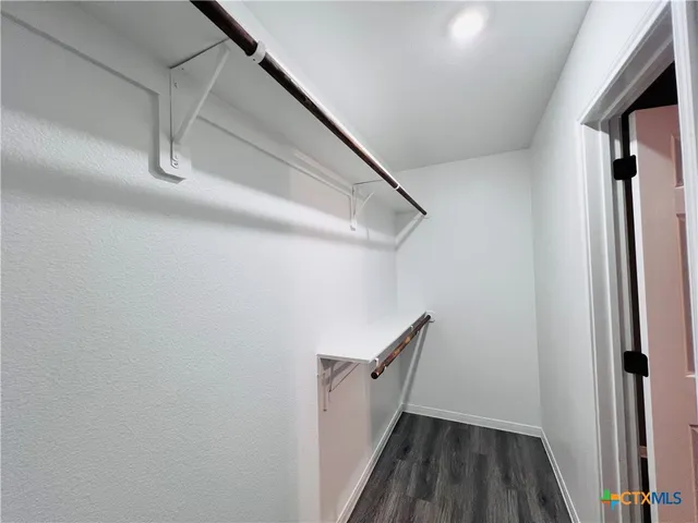 a view of a room with wooden floor