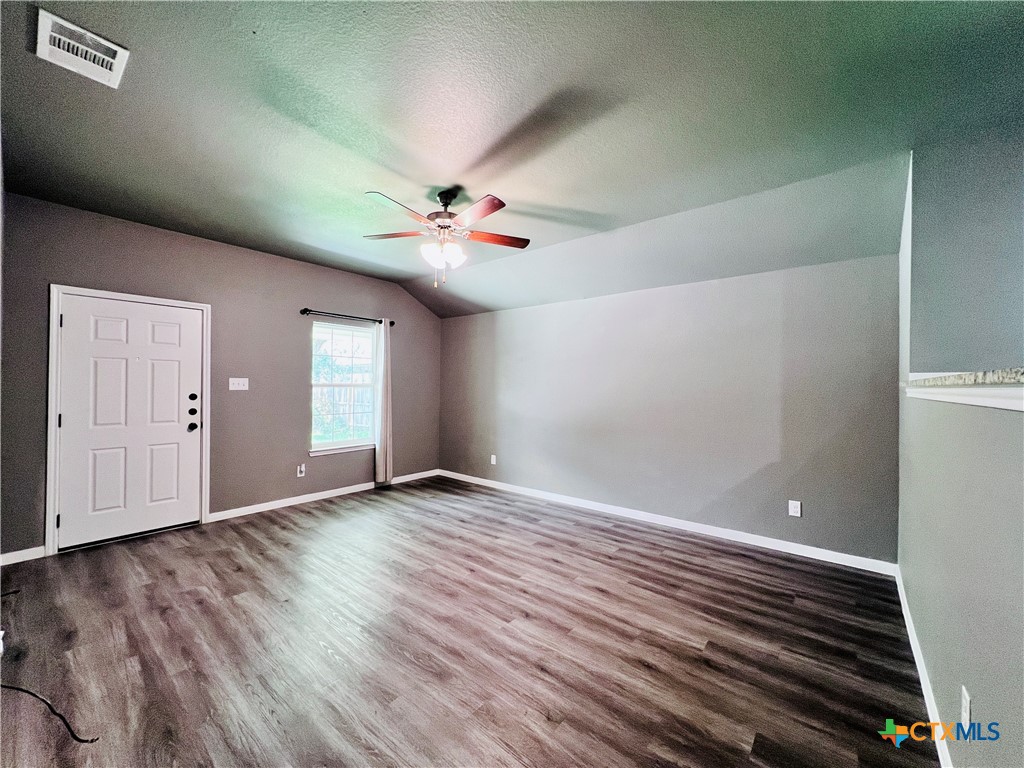 1403 Natchez Trail, Unit A Harker Heights, TX 76548 - Photo 2 of 14 an empty room with wooden floor and fan