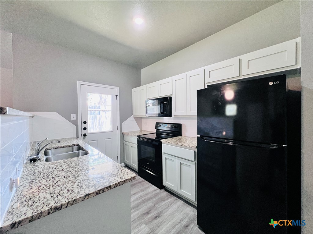 1403 Natchez Trail, Unit A Harker Heights, TX 76548 - Photo 3 of 14 a kitchen with a sink stainless steel appliances and counter space