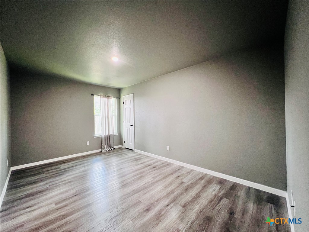 1403 Natchez Trail, Unit A Harker Heights, TX 76548 - Photo 8 of 14 a view of room with window and wooden floor