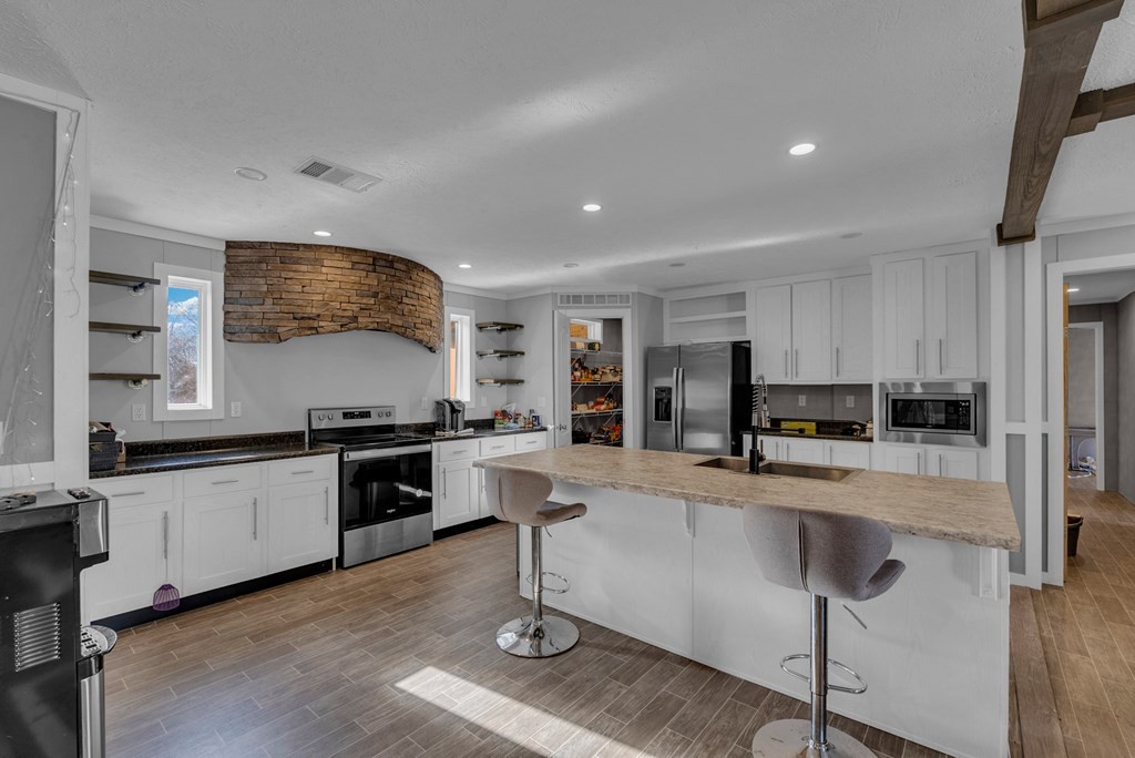 1083 Fanchers Mill Road Sparta, TN 38583 - Photo 11 of 67 a large kitchen with a large window and stainless steel appliances