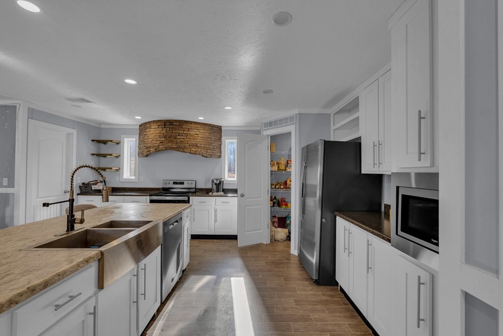 1083 Fanchers Mill Road Sparta, TN 38583 - Photo 12 of 67 a kitchen with stainless steel appliances granite countertop a sink stove and refrigerator