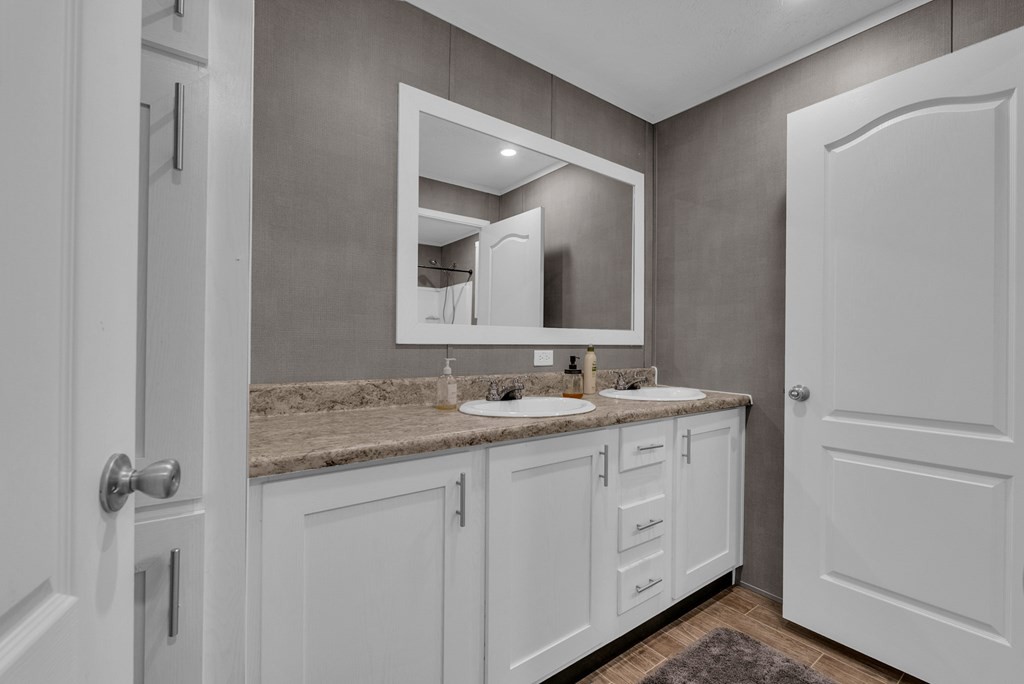 1083 Fanchers Mill Road Sparta, TN 38583 - Photo 21 of 67 a bathroom with a double vanity sink and mirror