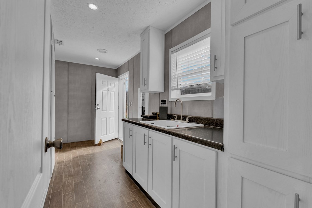 1083 Fanchers Mill Road Sparta, TN 38583 - Photo 28 of 67 a kitchen with stainless steel appliances granite countertop a sink and cabinets with wooden floor