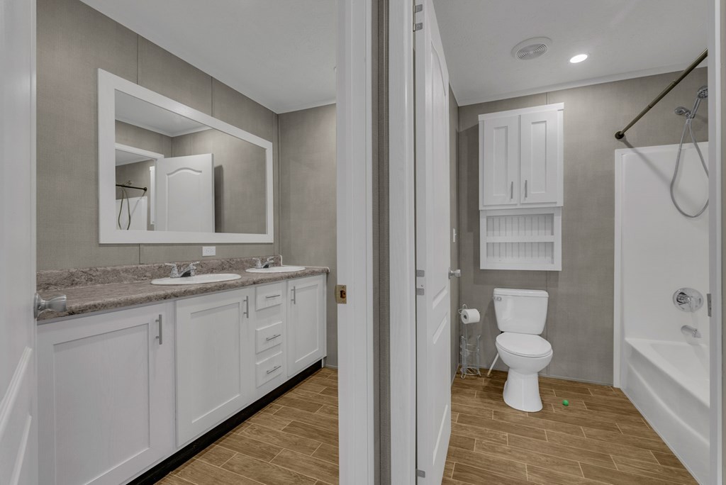 1083 Fanchers Mill Road Sparta, TN 38583 - Photo 36 of 67 a bathroom with a granite countertop sink a toilet and a mirror