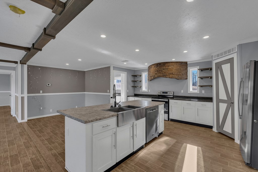 1083 Fanchers Mill Road Sparta, TN 38583 - Photo 9 of 67 a kitchen with stainless steel appliances granite countertop a sink stove and refrigerator