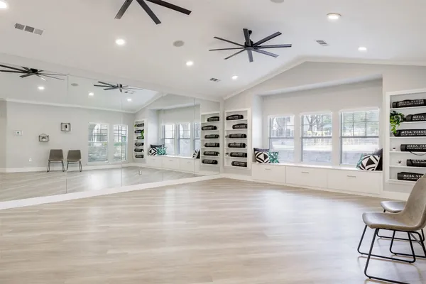 a living room with stainless steel appliances furniture and a large window