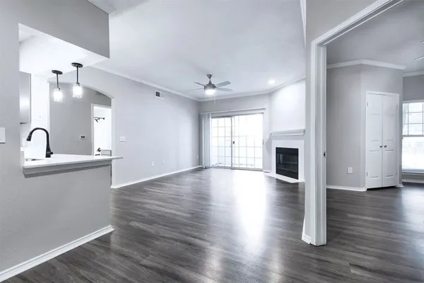 a view of empty room with wooden floor and fireplace