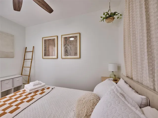 a bedroom with a large bed and a large window