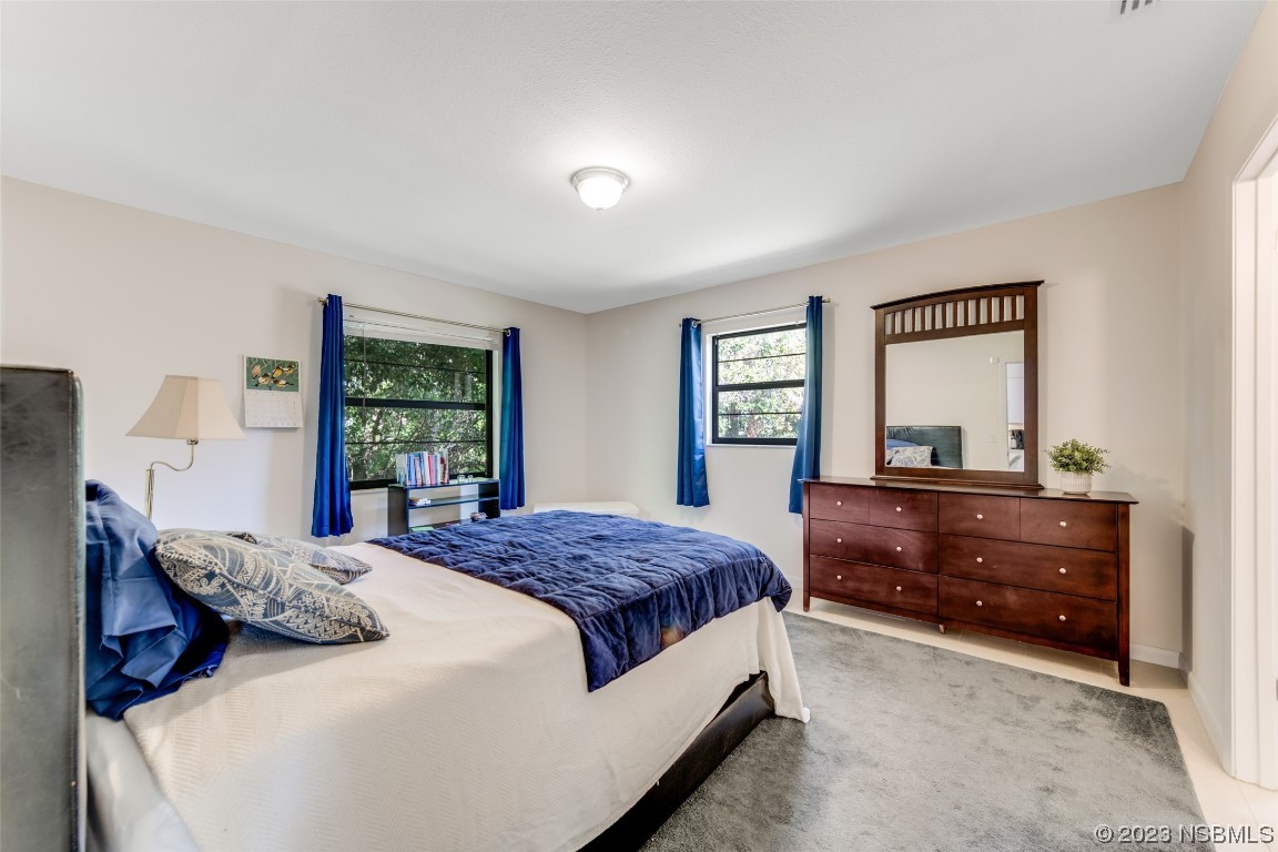 17 Pelican Drive Edgewater, FL 32141 - Photo 11 of 32 a bedroom with a bed and a window