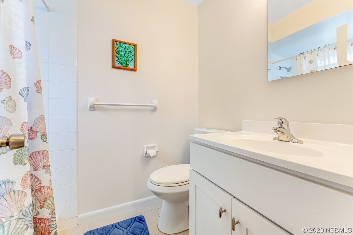 17 Pelican Drive Edgewater, FL 32141 - Photo 12 of 32 a bathroom with a granite countertop sink toilet and a mirror