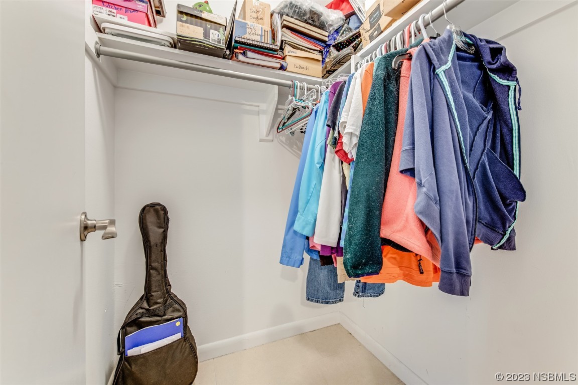 17 Pelican Drive Edgewater, FL 32141 - Photo 14 of 32 a view of walk in closet with clothes and shoes